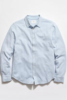 Light blue textured shirt on a white background
