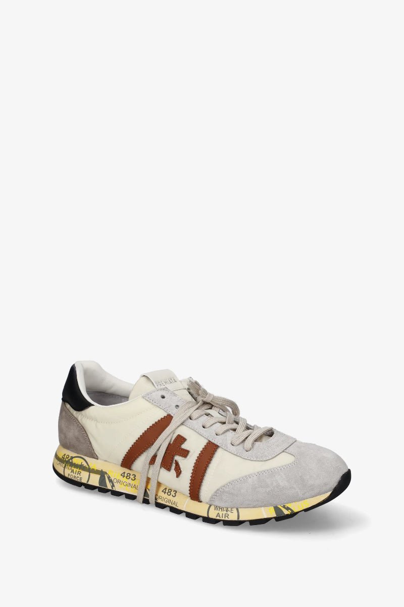 Sneaker with a brown stripe on a white background