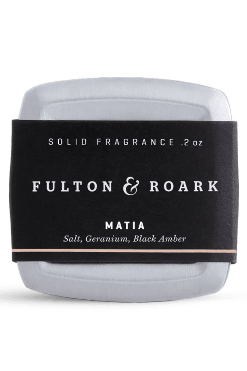 Solid fragrance container with 'Fulton & Roark' label on a white background