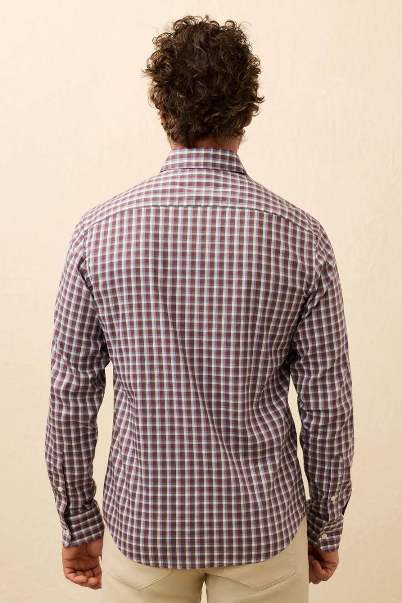 Man wearing a red and white checkered shirt against a beige background