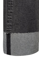 Close-up of black denim fabric with a white background