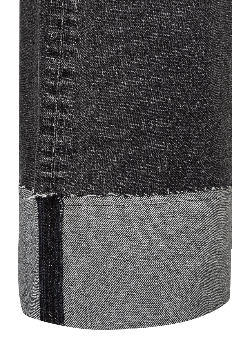 Close-up of black denim fabric with a white background