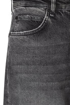 Close-up of dark gray jeans with a focus on the pocket area.