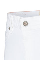 Close-up of white pants with a MAC label on a white background
