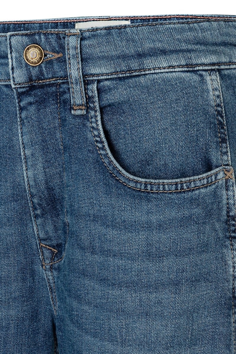 Close-up of blue denim jeans with a button and back pocket on a white background