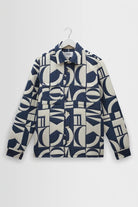 Navy and white patterned jacket on a hanger against a light gray background