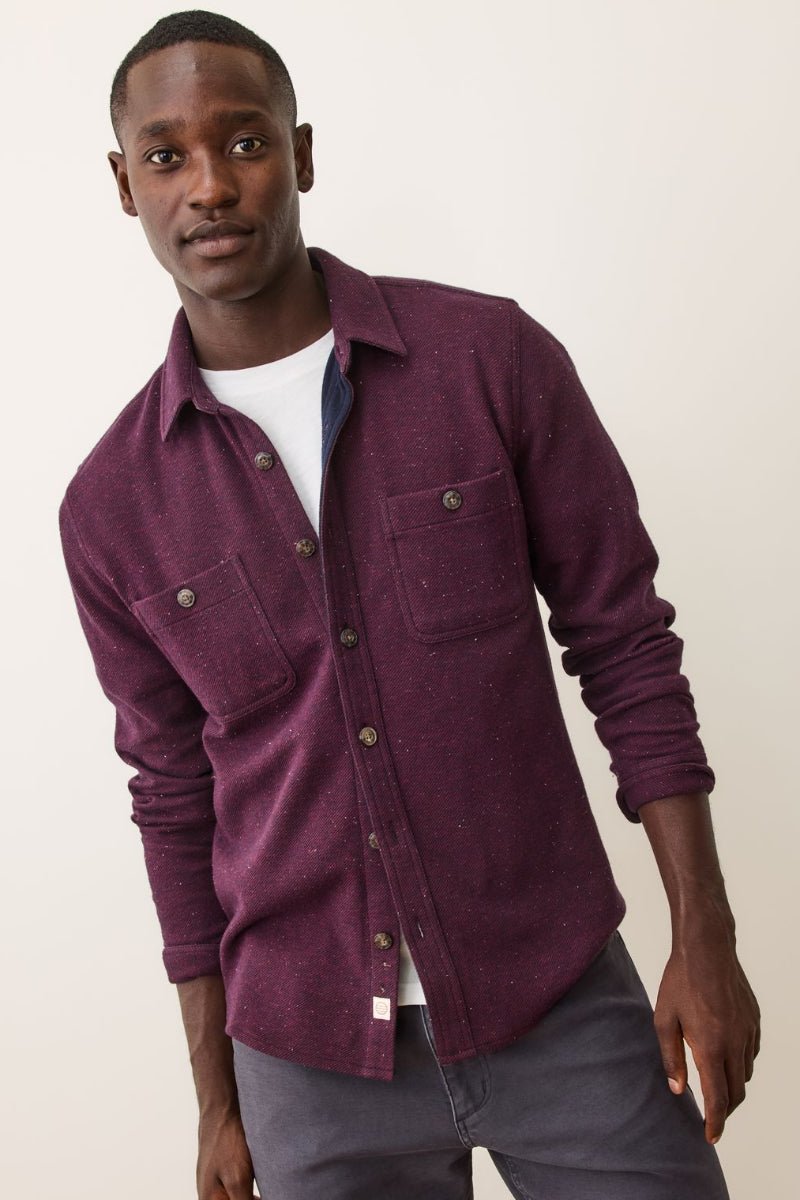 Man wearing a purple shirt with a white background