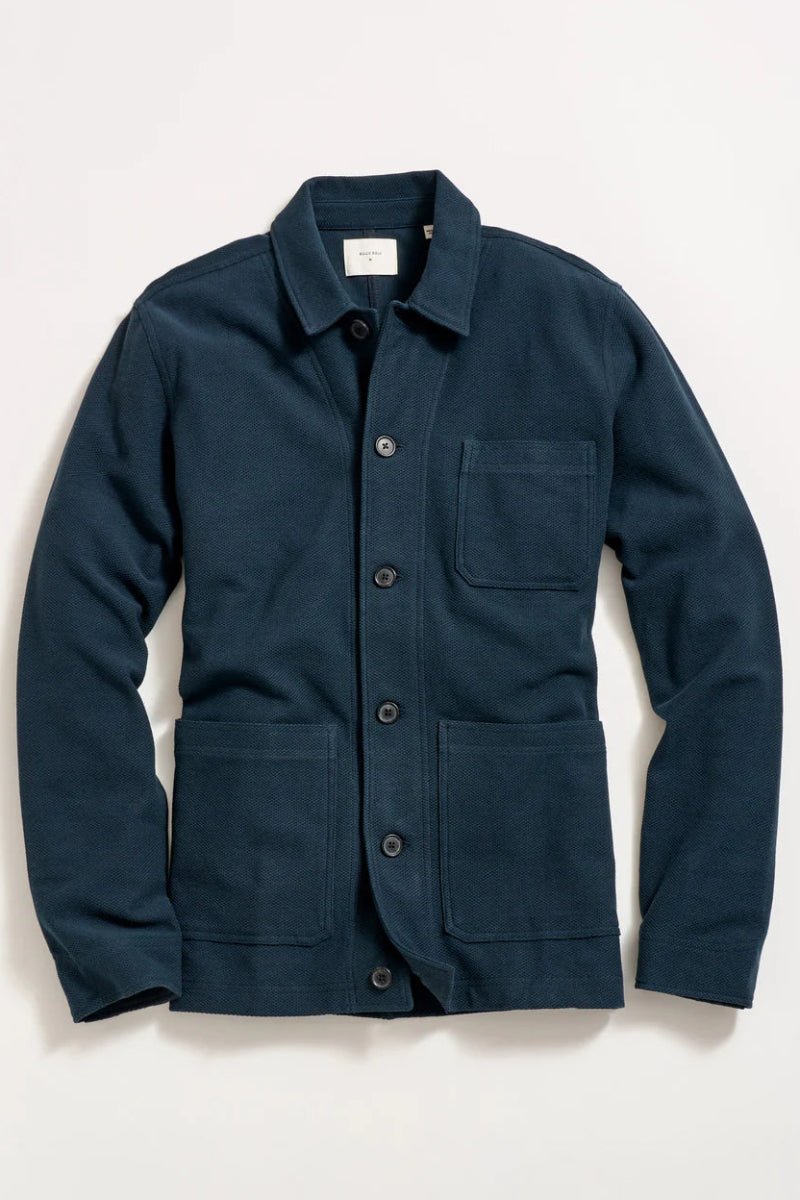 Navy blue jacket with multiple pockets on a light beige background