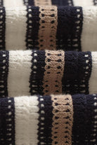 Close-up of striped fabric with black, beige, and white pattern