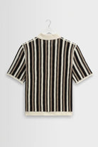 Black and white striped shirt on a hanger against a light gray background