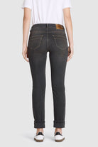 Person wearing black jeans with a white background