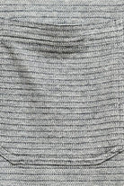 Close-up of gray textured fabric with a pocket