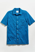 Blue short-sleeve shirt on a light gray background