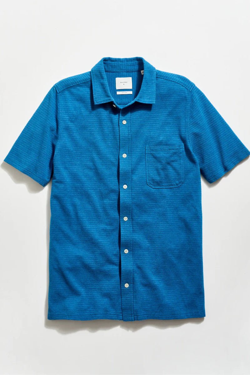 Blue short-sleeve shirt on a light gray background