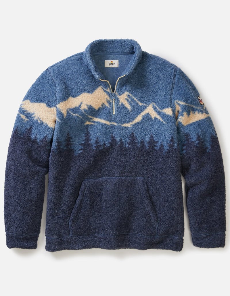 Blue fleece pullover with mountain design on a white background