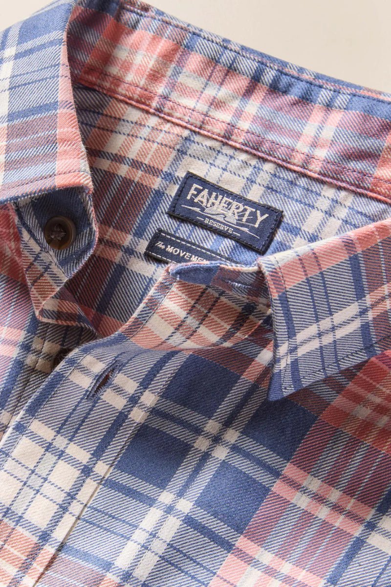 Close-up of a plaid shirt with a brand label on a beige background