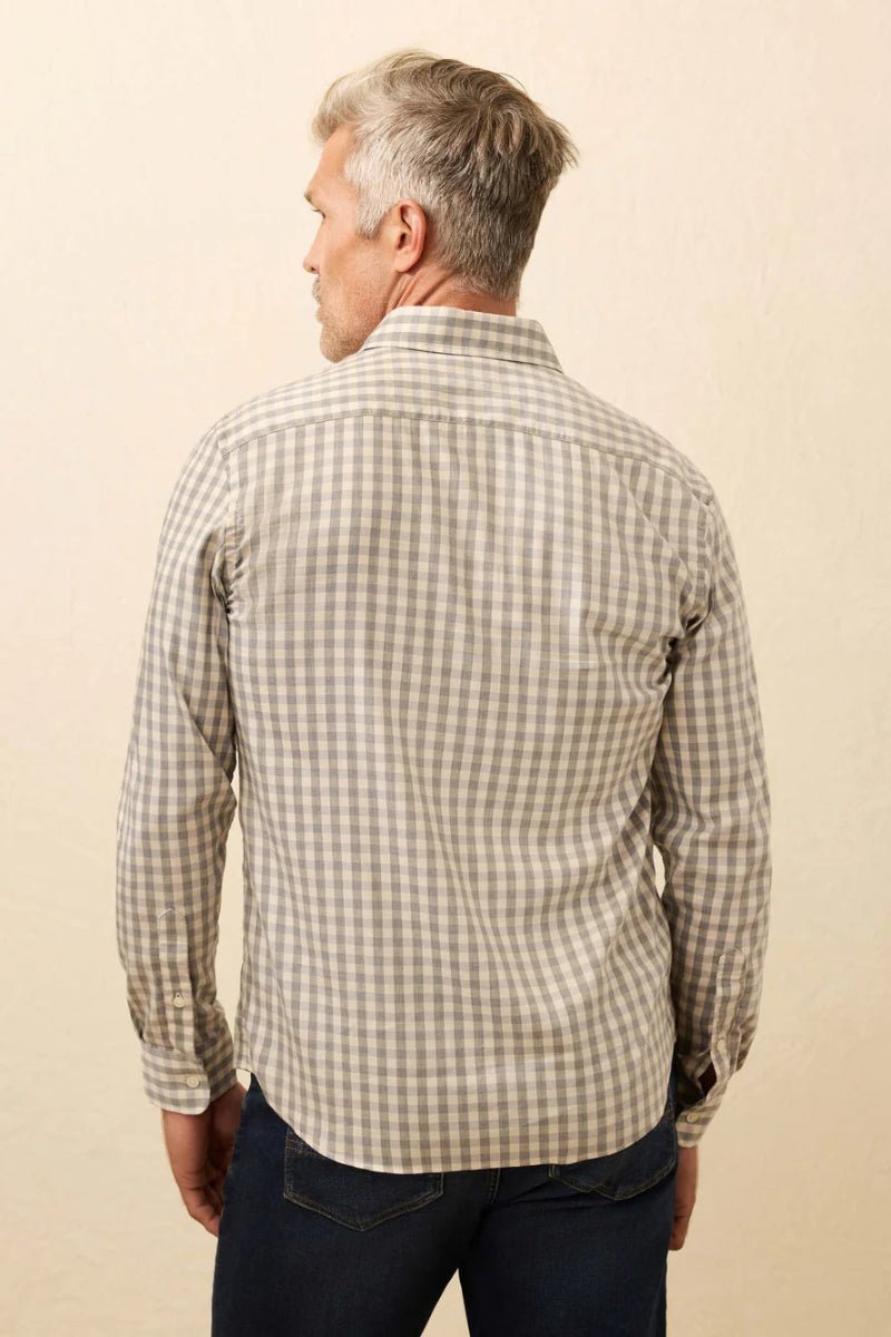 Man wearing a checkered shirt against a beige background