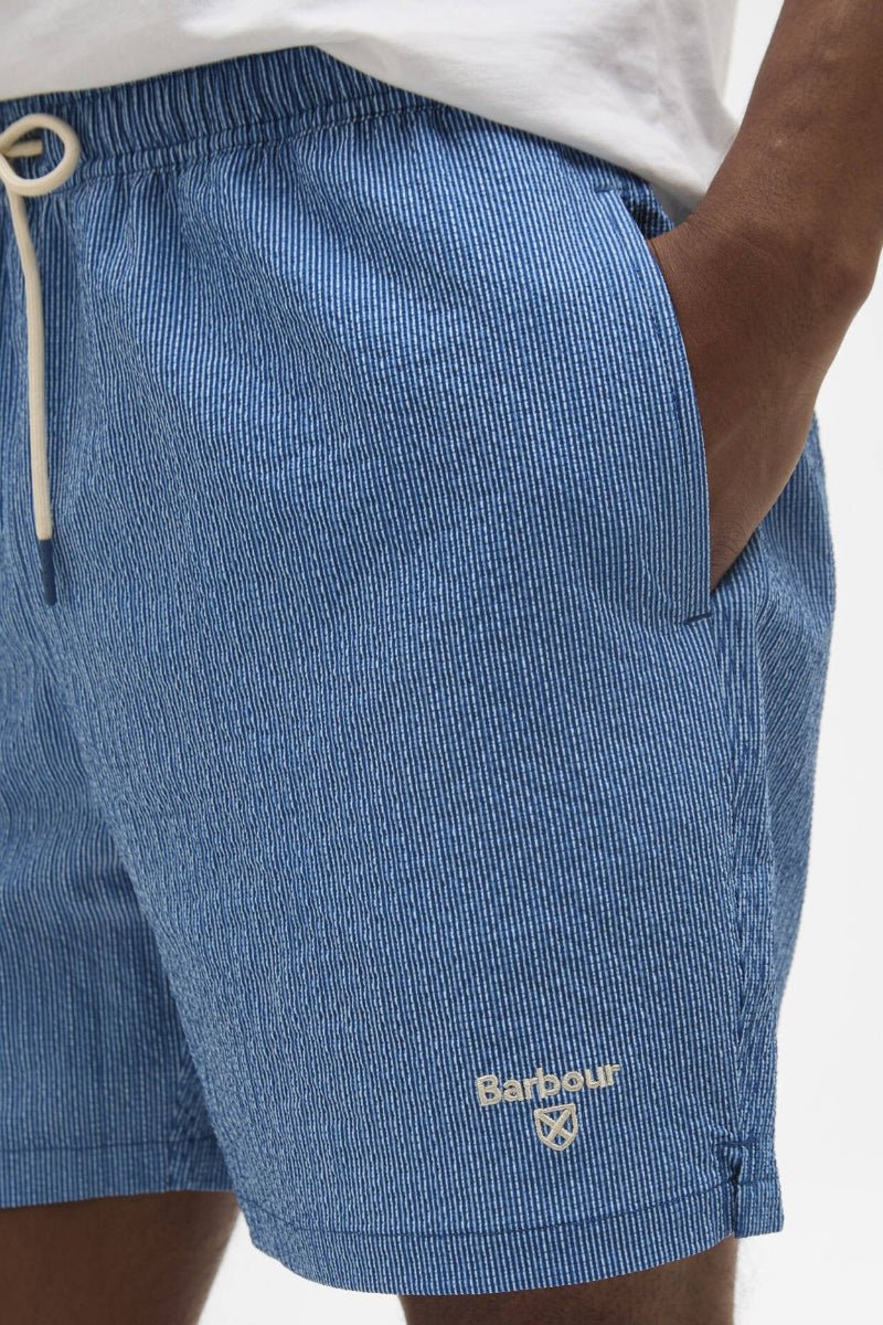 Blue shorts with a Barbour logo on a white background