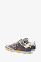 Pair of gray and white sneakers on a white background