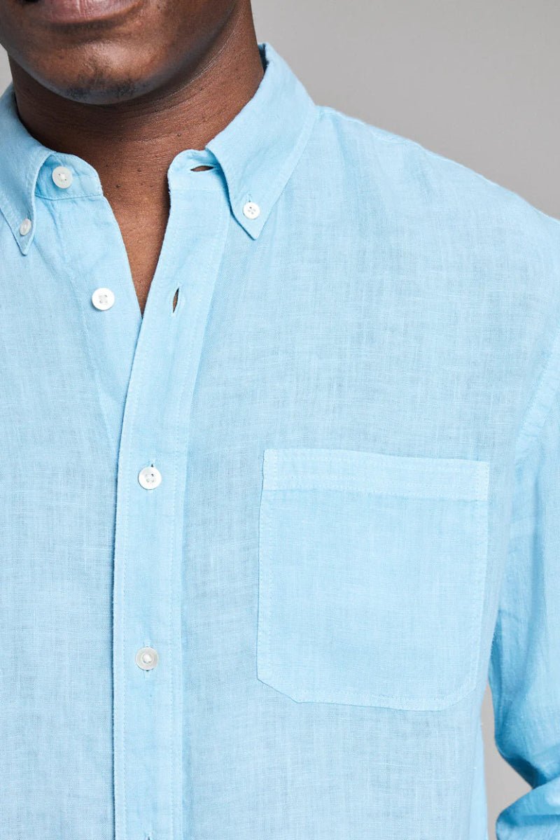 Light blue button-up shirt worn by a person on a neutral background