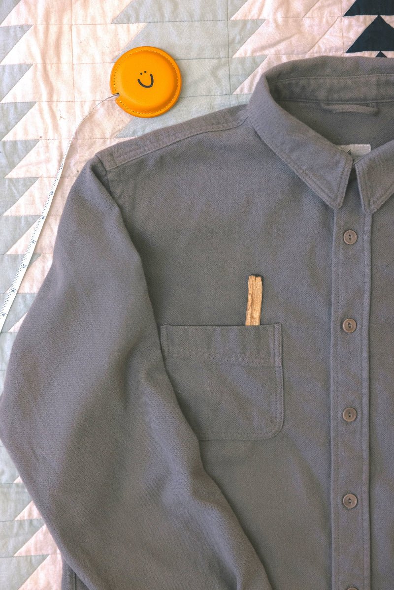 Green shirt with a pocket on a patterned fabric background