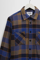Plaid shirt on a hanger with a white background