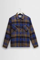 Plaid shirt on a hanger against a white background