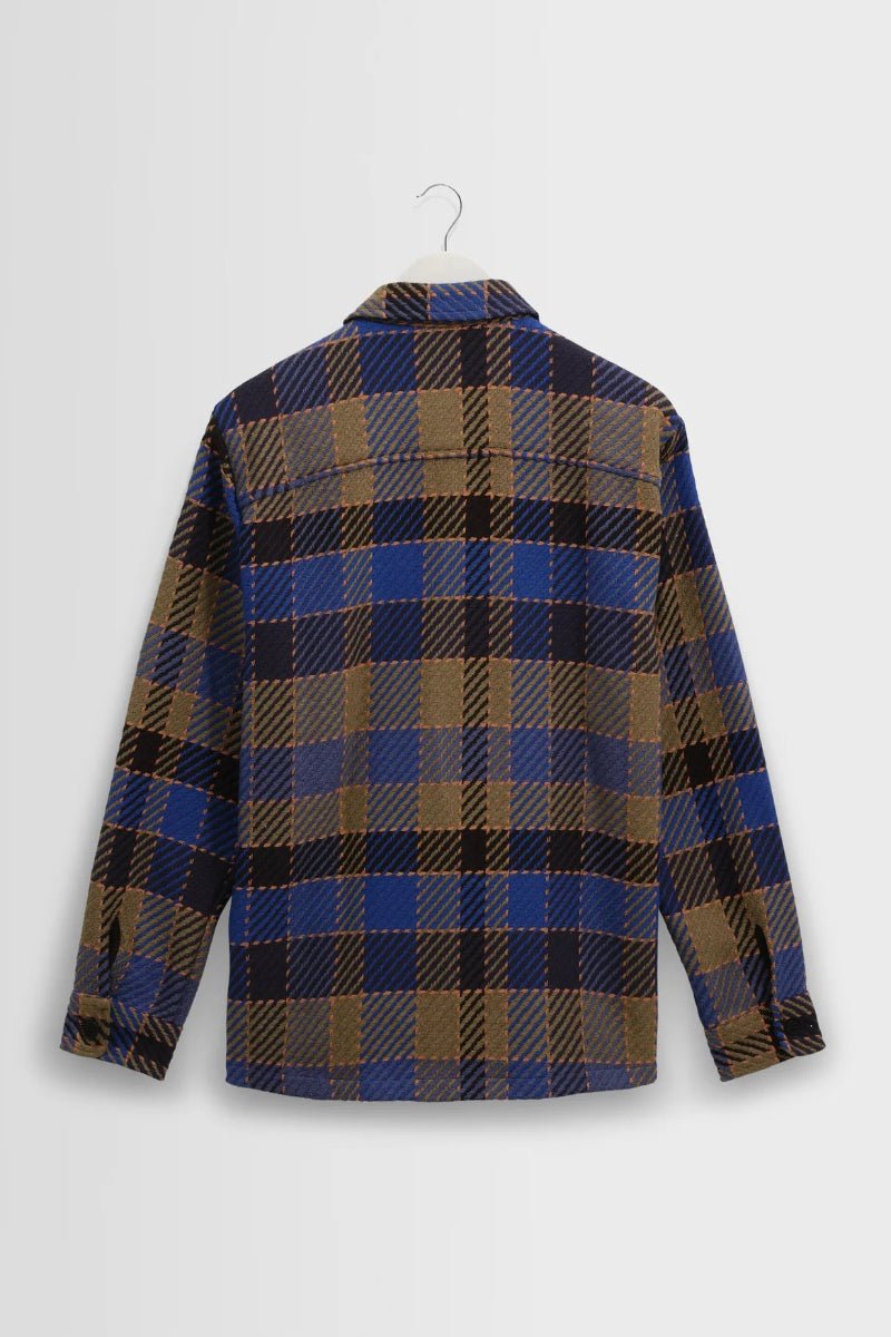 Plaid shirt on a hanger against a white background