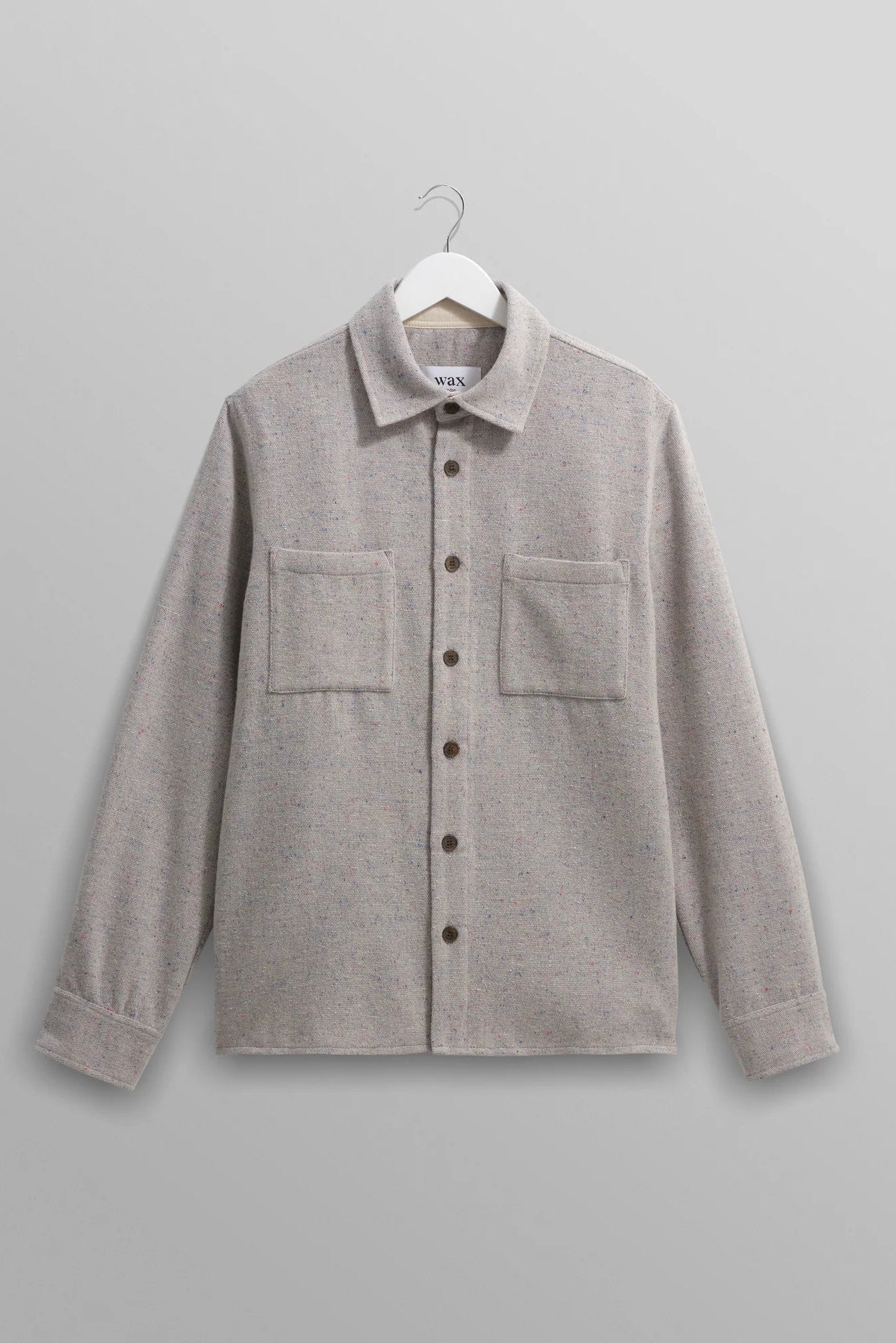 Gray shirt on a hanger against a gray background