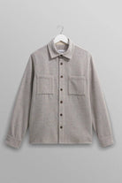 Gray shirt on a hanger against a gray background