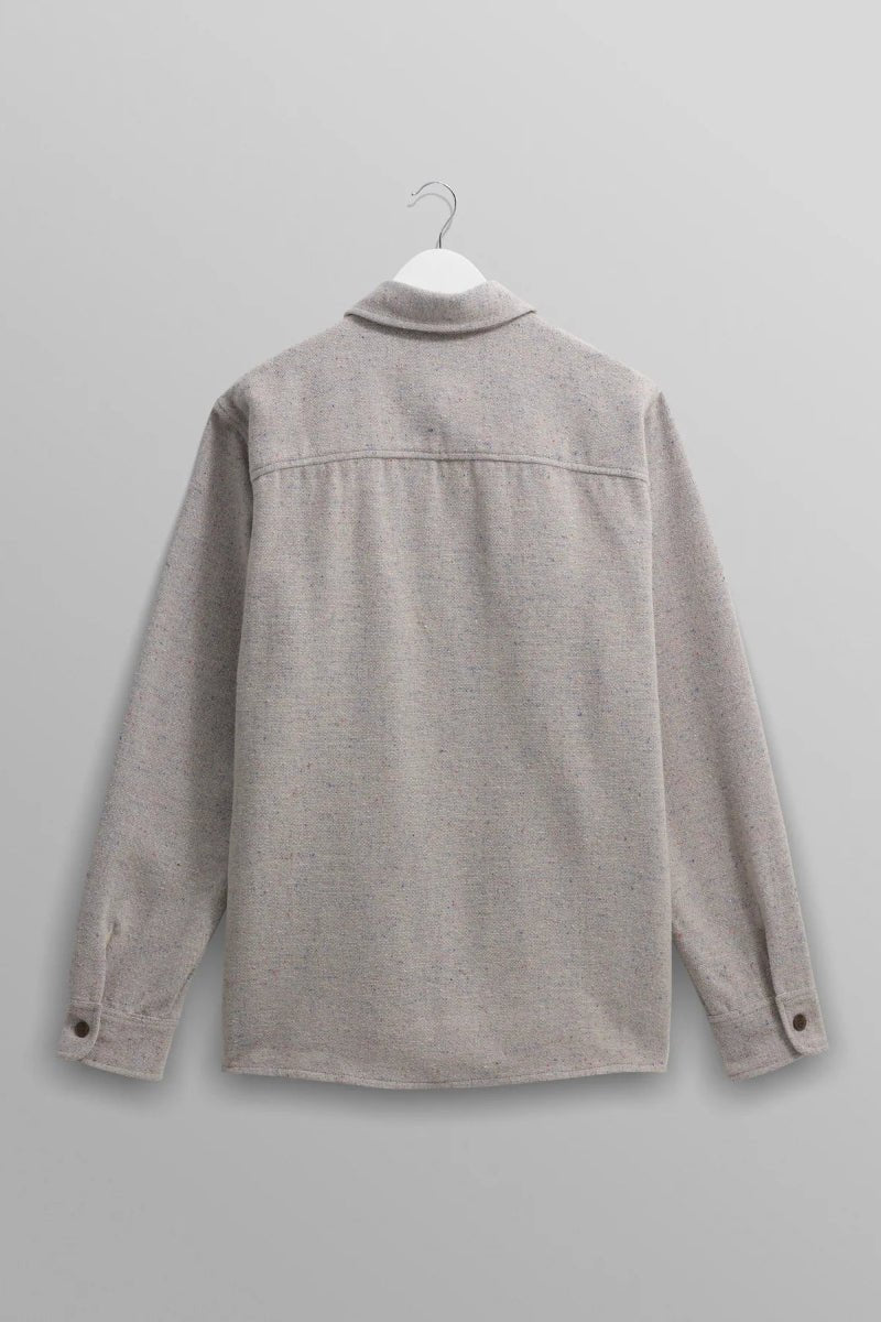 Gray shirt on a hanger against a gray background