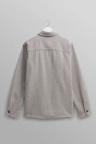Gray shirt on a hanger against a gray background