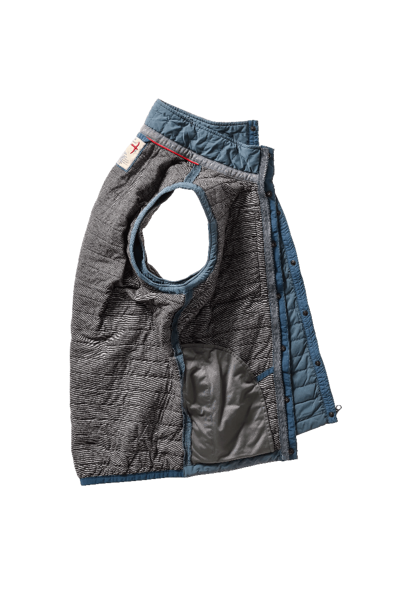 Quilted dog vest with gray and blue pattern on a white background
